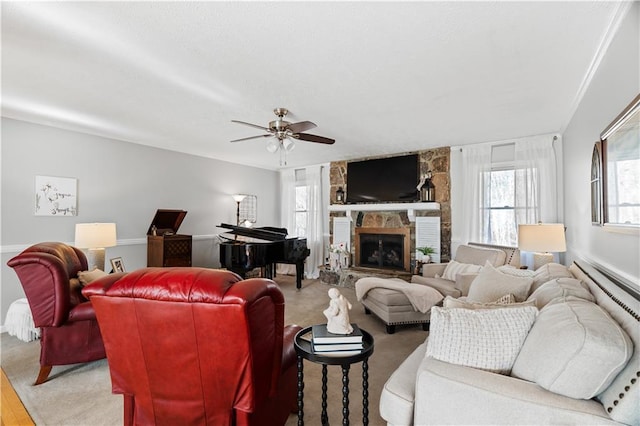 living room with ceiling fan and a fireplace