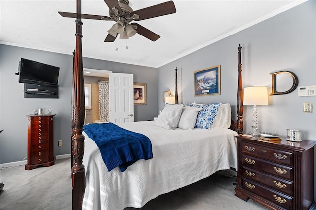 carpeted bedroom with ceiling fan and ornamental molding