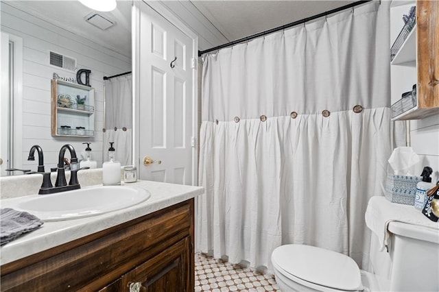 bathroom with vanity, toilet, and crown molding