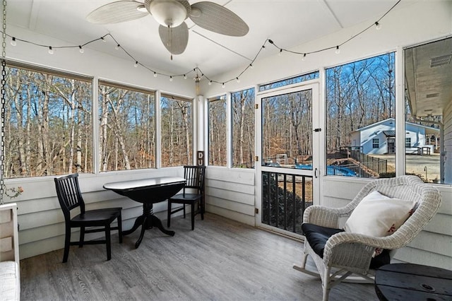 sunroom / solarium featuring ceiling fan