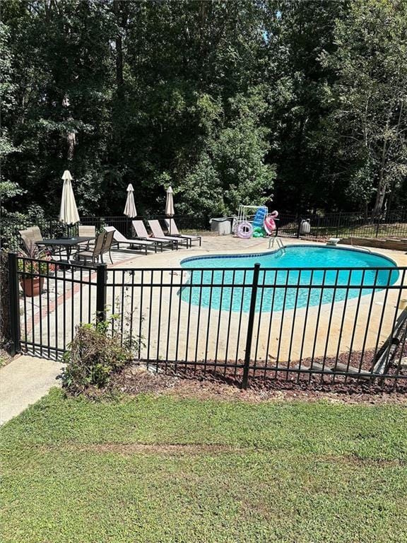 view of pool featuring a patio and a diving board