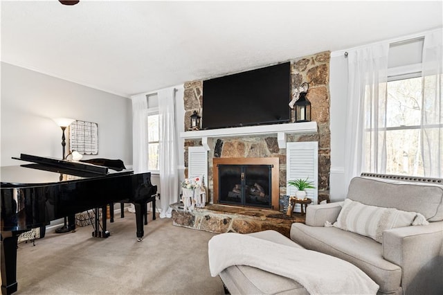 sitting room with a fireplace and carpet floors