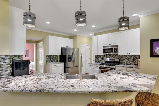 kitchen featuring white cabinets, appliances with stainless steel finishes, and tasteful backsplash