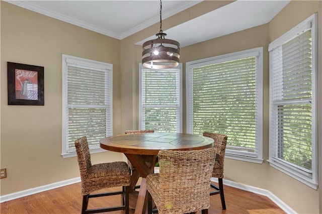 dining space featuring light hardwood / wood-style flooring and ornamental molding