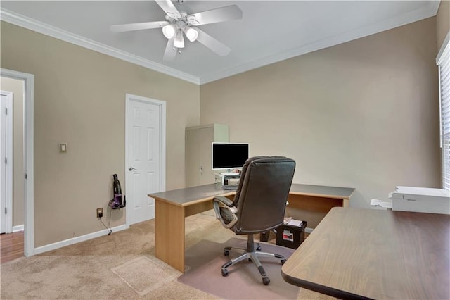 office space with ceiling fan, light colored carpet, and ornamental molding