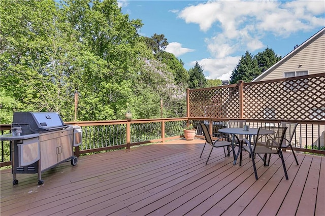 wooden terrace with a grill