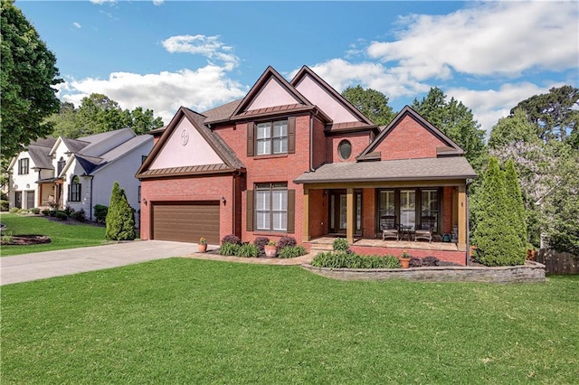 view of front of house featuring covered porch, a front lawn, and a garage