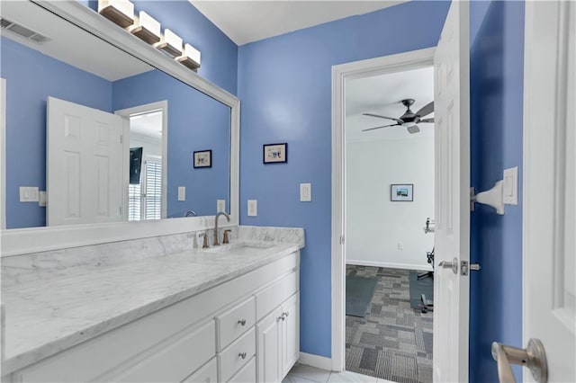 bathroom with ceiling fan, tile floors, and vanity