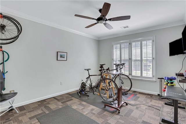 exercise room featuring ceiling fan and ornamental molding