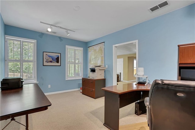 office featuring light carpet and rail lighting