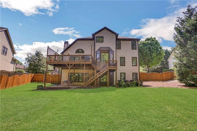 back of house featuring a deck, a patio, and a yard