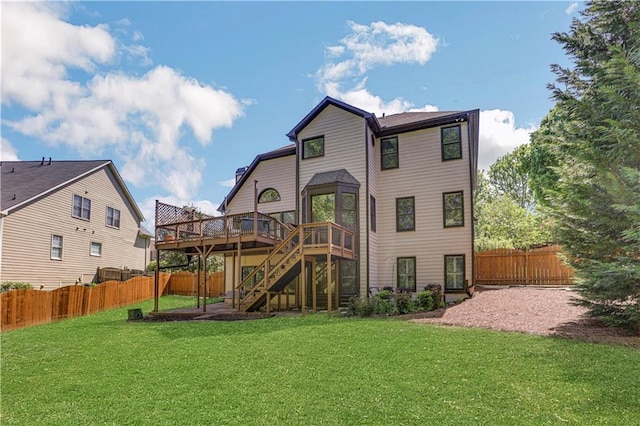 back of house with a lawn and a deck