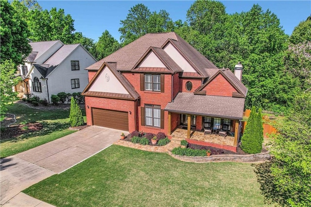 view of front of home with a front lawn and a garage