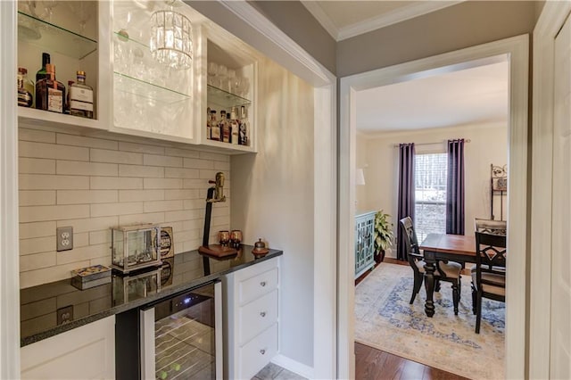 82 Cedar Blf, Winder, GA 30680 - indoor dry bar with wine cooler, crown molding, tasteful backsplash, and wood finished floors