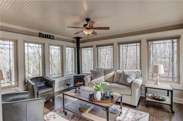 82 Cedar Blf, Winder, GA 30680 - sunroom / solarium with a wood stove, healthy amount of natural light, crown molding, and wood-type flooring