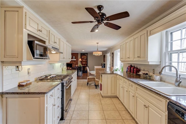 82 Cedar Blf, Winder, GA 30680 - kitchen with stainless steel appliances, cream cabinets, tasteful backsplash, light tile patterned flooring, and under cabinet range hood