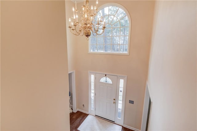 82 Cedar Blf, Winder, GA 30680 - entrance foyer with a chandelier, healthy amount of natural light, a towering ceiling, and dark wood-type flooring