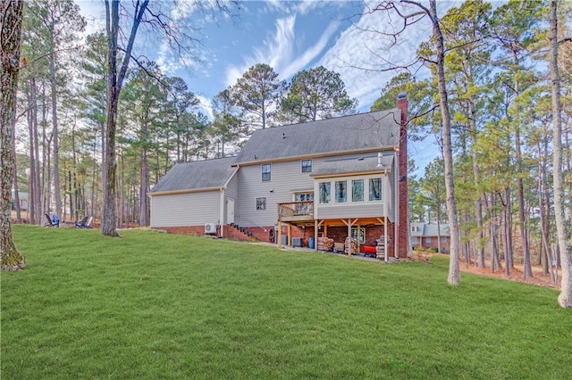 82 Cedar Blf, Winder, GA 30680 - back of house with a chimney, a deck, and a lawn