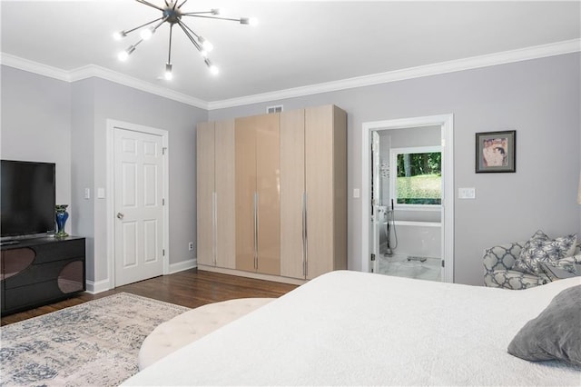 bedroom with connected bathroom, baseboards, ornamental molding, wood finished floors, and a notable chandelier