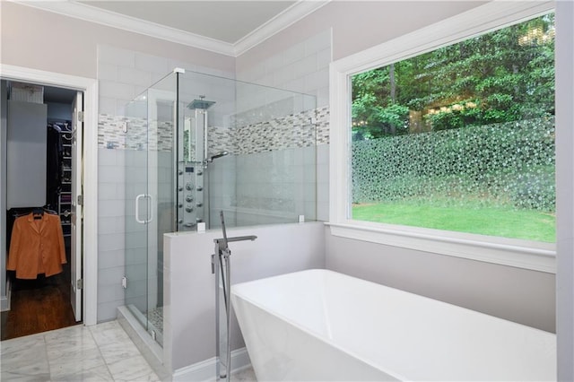 bathroom featuring a soaking tub, ornamental molding, a shower stall, a spacious closet, and marble finish floor