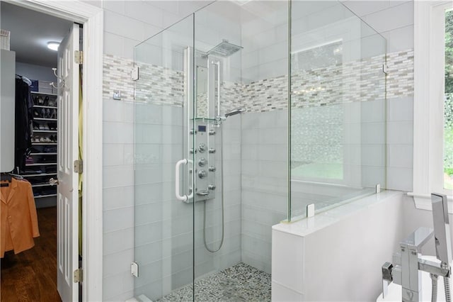 full bathroom with wood finished floors and a stall shower