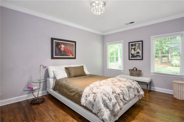 bedroom featuring visible vents, multiple windows, wood finished floors, and crown molding