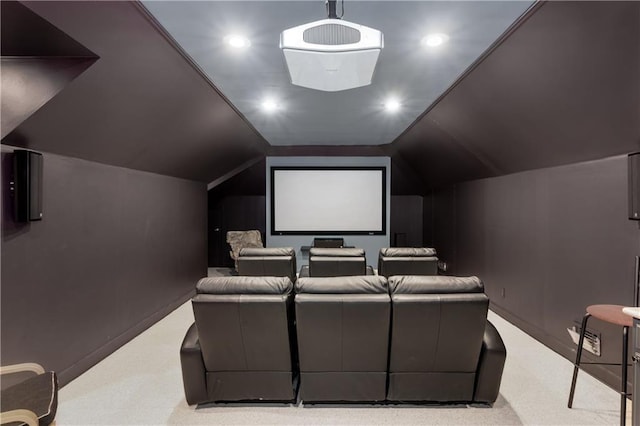 carpeted home theater featuring vaulted ceiling and recessed lighting