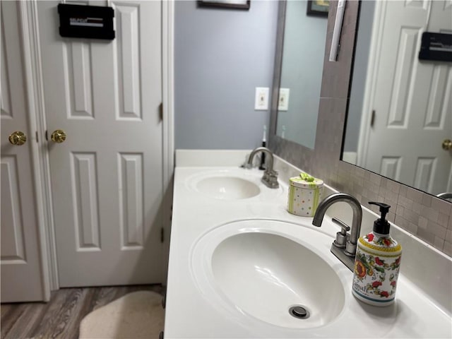 4172 Howell Park Rd, Duluth, GA 30096 - bathroom featuring double vanity, decorative backsplash, and wood finished floors