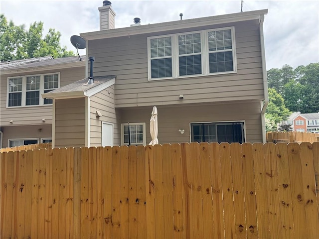 4172 Howell Park Rd, Duluth, GA 30096 - back of house featuring a chimney