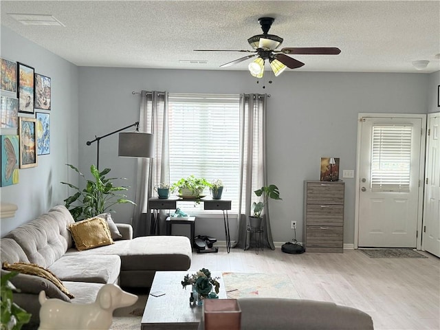 4172 Howell Park Rd, Duluth, GA 30096 - living area with ceiling fan, wood finished floors, healthy amount of natural light, and a textured ceiling