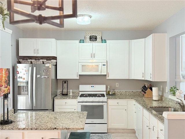 4172 Howell Park Rd, Duluth, GA 30096 - kitchen featuring white appliances, white cabinetry, light stone countertops, and a textured ceiling