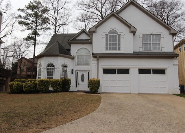 view of front of home featuring a garage and a front yard