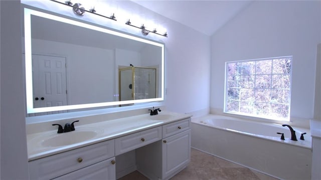 full bathroom with double vanity, lofted ceiling, a stall shower, a sink, and a bath