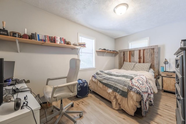 1279 Skyhaven Rd SE, Atlanta, GA 30316 - bedroom with light wood finished floors and a textured ceiling