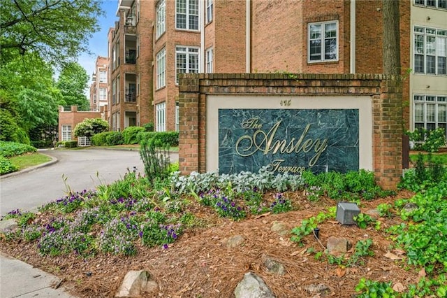 community sign featuring a garage and driveway