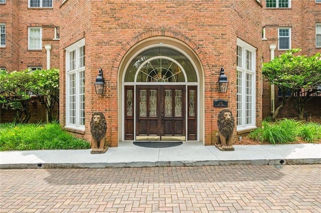 doorway to property featuring french doors and brick siding