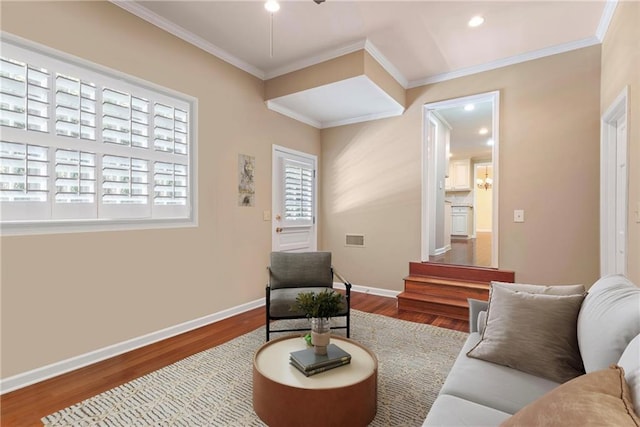 living room with ornamental molding and hardwood / wood-style floors