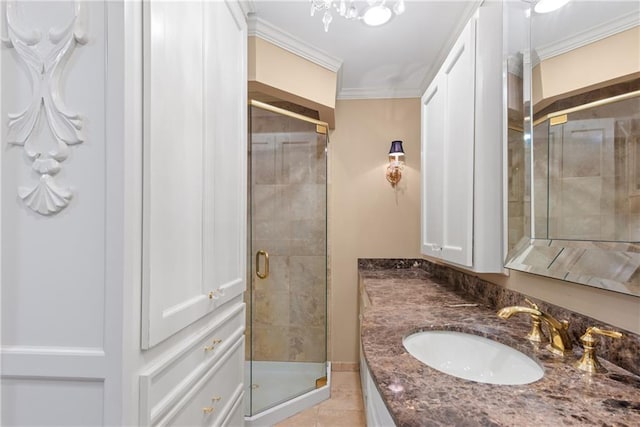 bathroom featuring tile patterned flooring, ornamental molding, vanity, and a shower with shower door