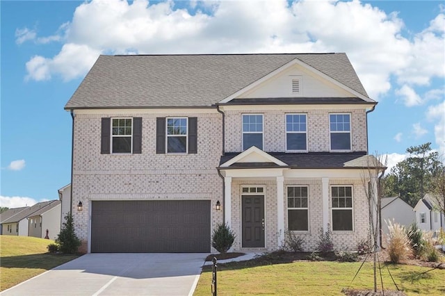 view of front of property with a front lawn and a garage