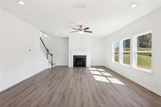 unfurnished living room with ceiling fan and hardwood / wood-style flooring