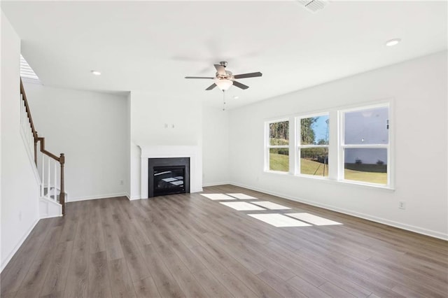 unfurnished living room with ceiling fan and light wood-type flooring