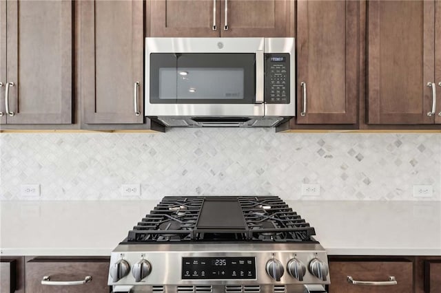 kitchen with backsplash, dark brown cabinetry, and stainless steel appliances