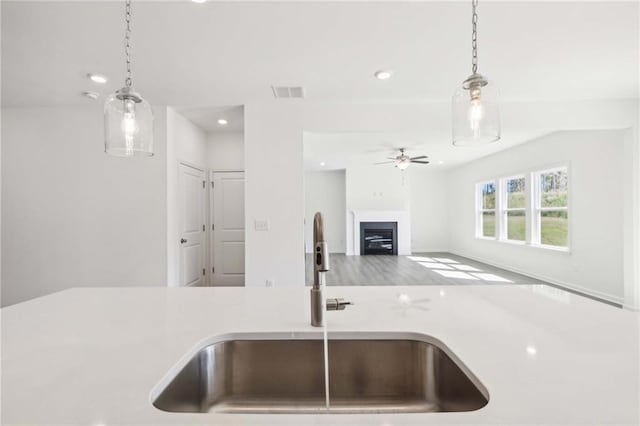 kitchen with pendant lighting, ceiling fan, and sink