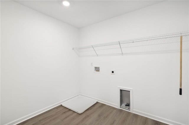 laundry area featuring hookup for an electric dryer, dark wood-type flooring, and washer hookup