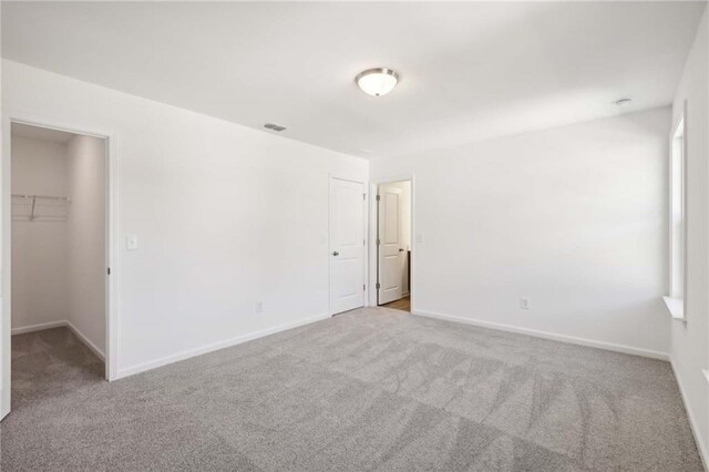 carpeted spare room featuring a healthy amount of sunlight