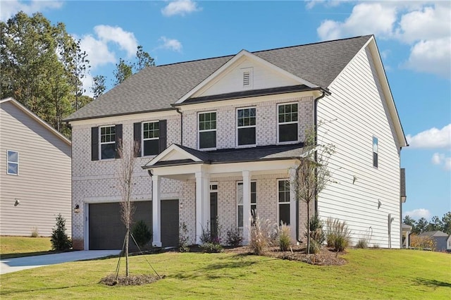 view of front of property featuring a front yard and a garage