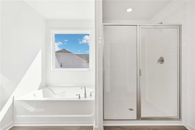 bathroom featuring separate shower and tub