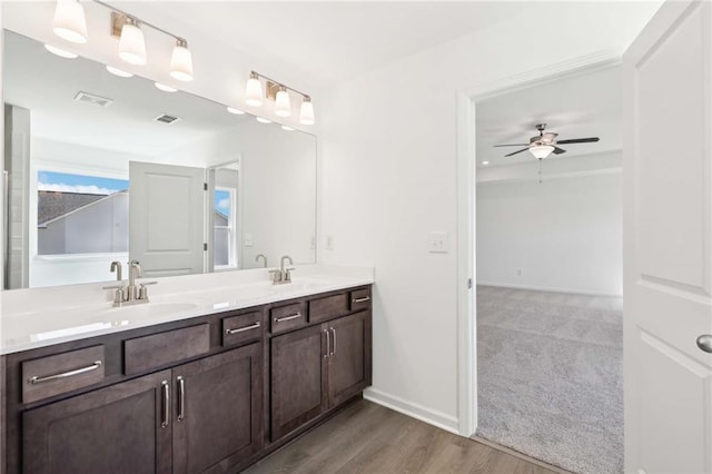 bathroom featuring ceiling fan, wood-type flooring, and vanity