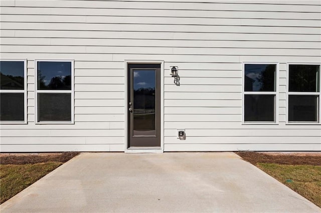 property entrance with a patio