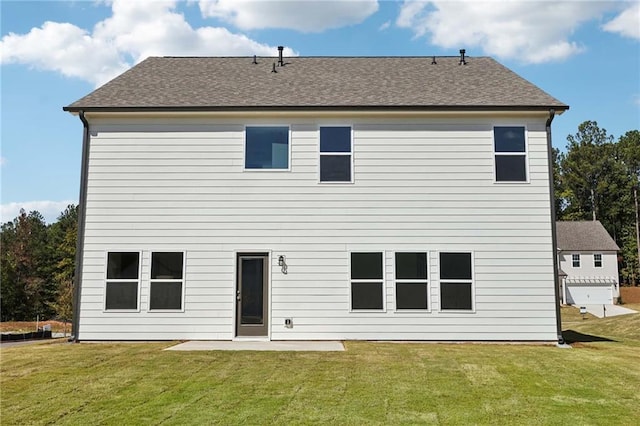 back of property with a yard and a patio